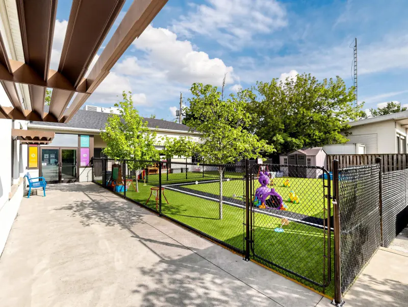 The covered walkway keeps outdoor play going on bright days.
